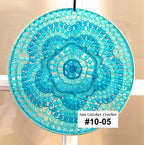 Turquoise beaded sun catcher with a label on a beige background