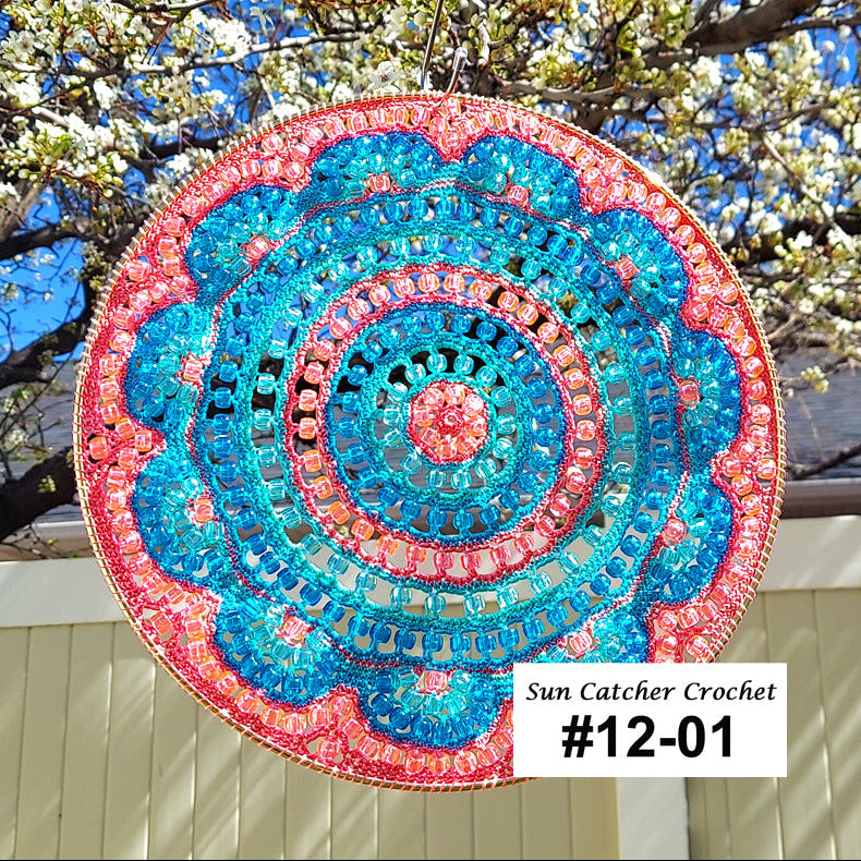 Decorative sun catcher with colorful spiral pattern hanging outdoors.