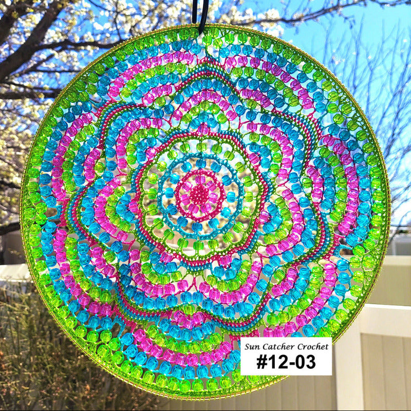 Colorful beaded sun catcher with a spiral pattern against a natural background
