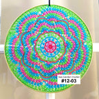 Colorful beaded sun catcher with a spiral pattern on a white background