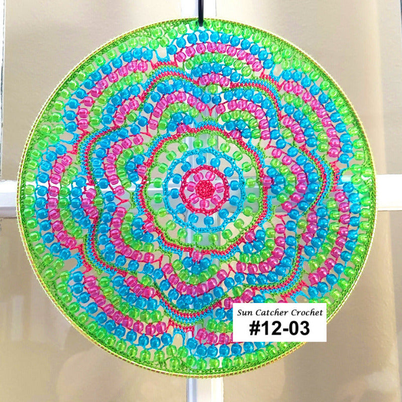 Colorful beaded sun catcher with a spiral pattern on a white background