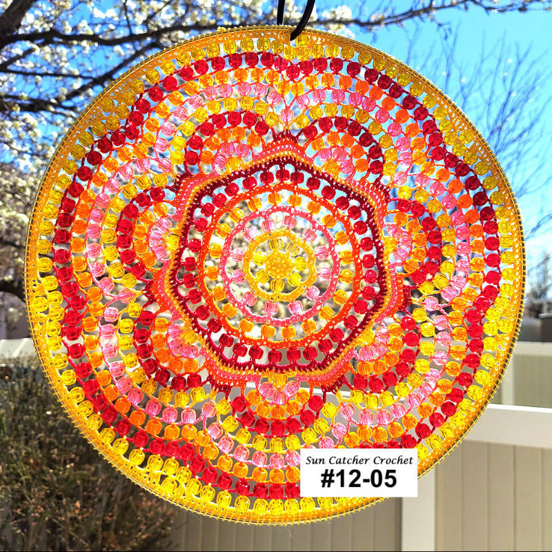 Colorful sun catcher with a spiral pattern against a natural background