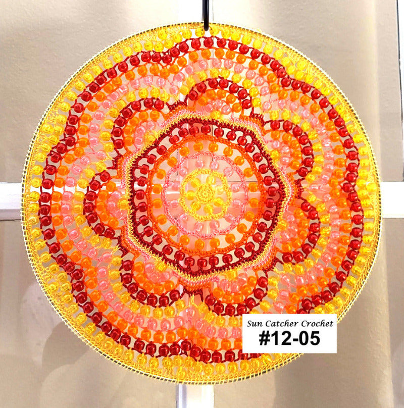 Decorative sun catcher with colorful spiral pattern on a plain background