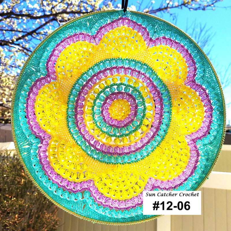 Colorful sun catcher with a spiral pattern against a blurred outdoor background