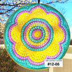 Colorful sun catcher with a spiral pattern against a blurred outdoor background