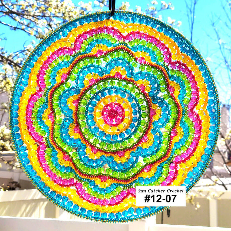 Colorful beaded sun catcher with a blurred outdoor background