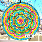 Colorful beaded sun catcher with a blurred outdoor background