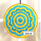 Decorative sun catcher with blue and yellow circular pattern on a white background