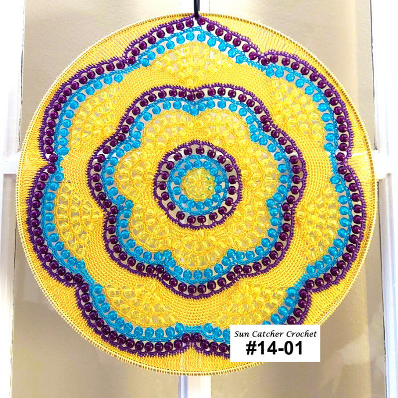 Decorative circular sun catcher with yellow, blue, and purple colors on a white background.