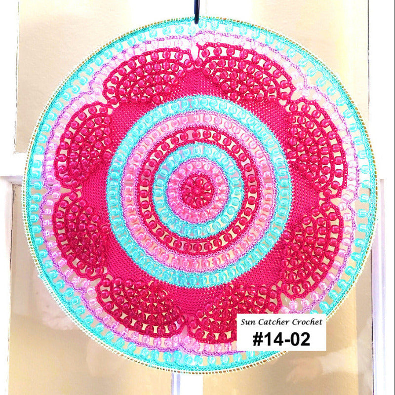 Colorful circular sun catcher with concentric patterns on a plain background