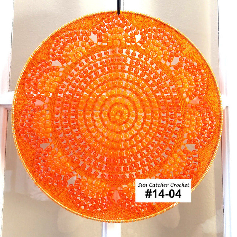 Circular sun catcher crochet item with a label on a white background