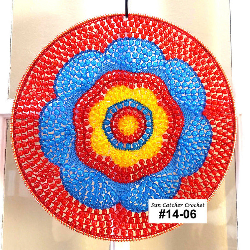 Colorful circular crochet wall hanging with red, blue, and yellow concentric circles on a white background.