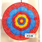 Colorful circular crochet wall hanging with red, blue, and yellow concentric circles on a white background.