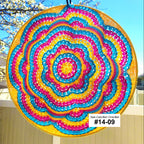 Colorful circular sun catcher with a blurred outdoor background
