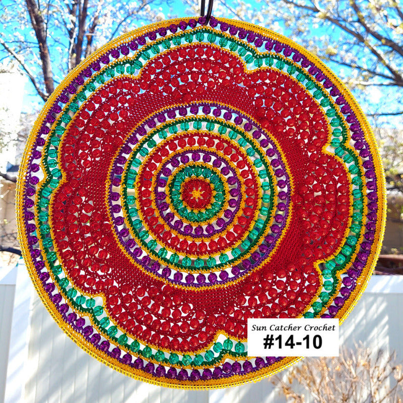 Colorful circular crochet sun catcher with a blurred outdoor background