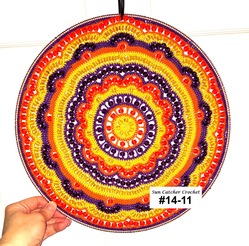 Colorful circular crochet pattern held by a hand with 'Sun Catcher Crochet' branding.