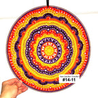 Colorful circular crochet pattern held by a hand with 'Sun Catcher Crochet' branding.
