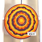 Colorful crocheted sun catcher with concentric circles on a white background