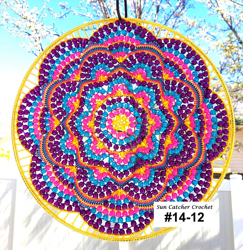 Colorful sun catcher crochet with a yellow frame against a natural background