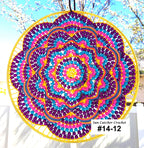 Colorful sun catcher crochet with a yellow frame against a natural background