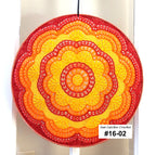 Round crochet sun catcher with a gradient of red to yellow on a white background