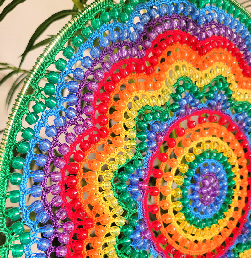 Colorful beaded doilies arranged in a circular pattern.