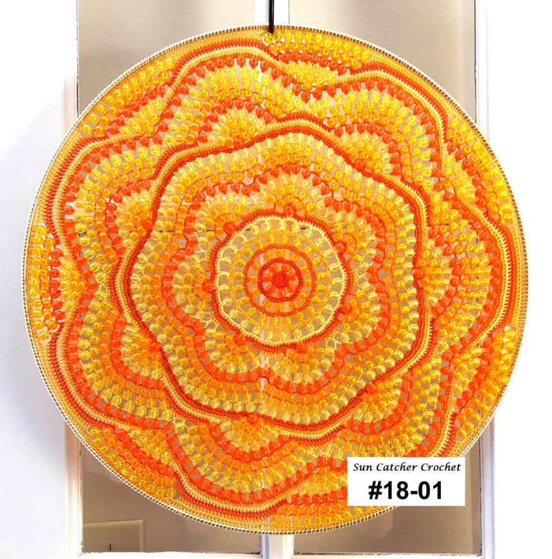 Sun catcher crochet with orange and yellow colors on a white background