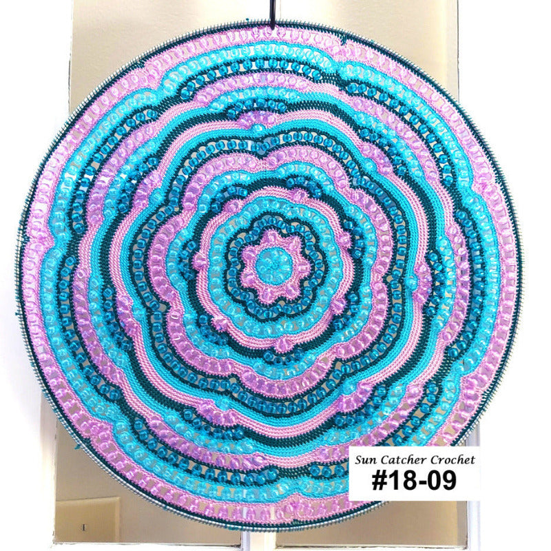 Decorative circular wall hanging with concentric patterns in blue and lilac on a white background.