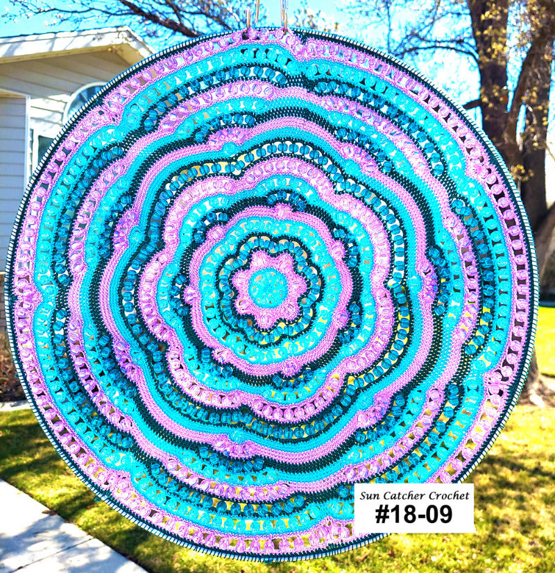 Colorful circular crochet design in a garden setting
