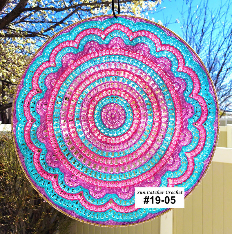 Colorful circular sun catcher with intricate patterns against a natural background