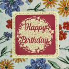 Happy Birthday card on a floral fabric background