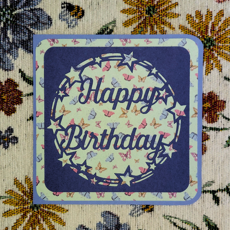 Birthday card with butterfly design on a floral background