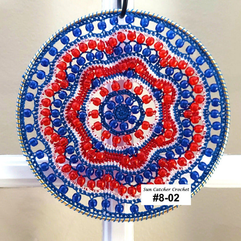 Decorative sun catcher with red, white, and blue pattern on a plain background