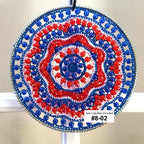 Decorative sun catcher with red, white, and blue pattern on a plain background
