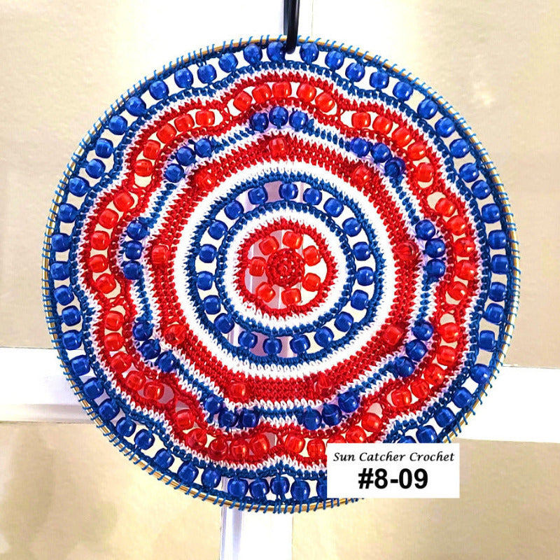 Decorative sun catcher with red and blue spiral pattern on a beige background