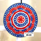 Decorative sun catcher with red and blue spiral pattern on a beige background