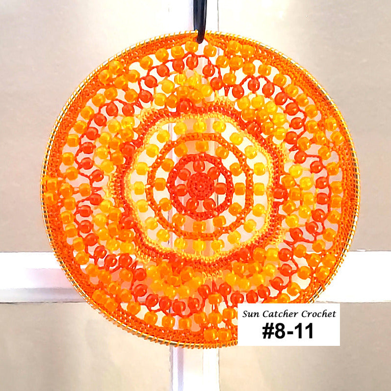 Round sun catcher with orange and yellow pattern on a white background