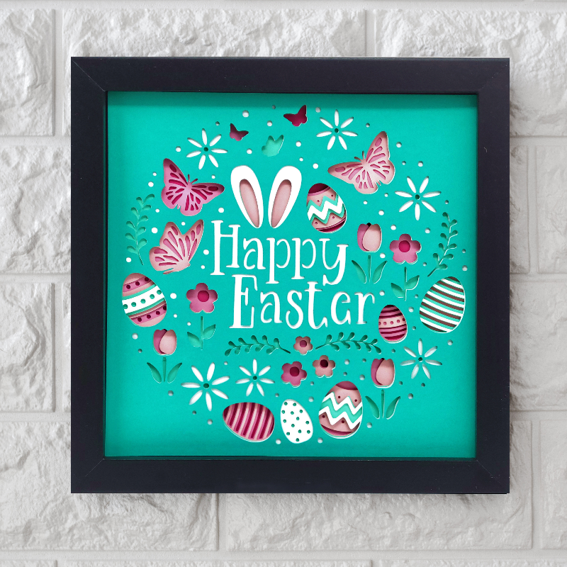 Framed 'Happy Easter' artwork with colorful eggs and flowers on a teal background.