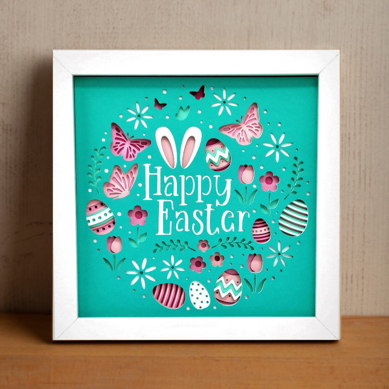 Framed 'Happy Easter' artwork with colorful designs on a teal background.