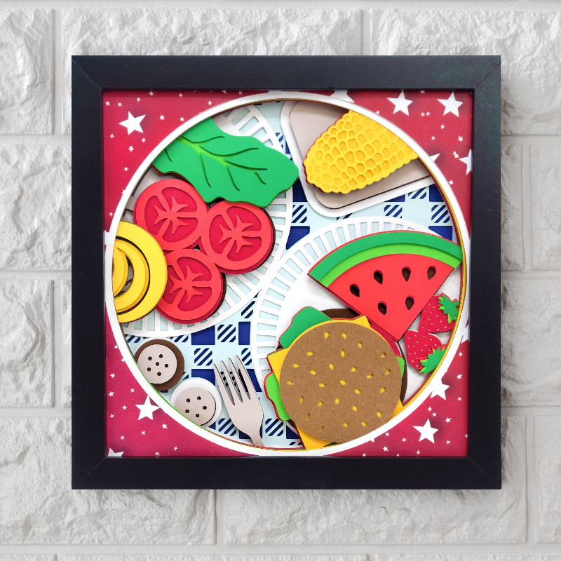 Framed artwork of food items on a plate with a red background