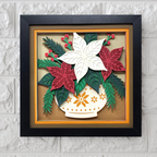 Framed paper art of poinsettias and a teacup on a textured wall background