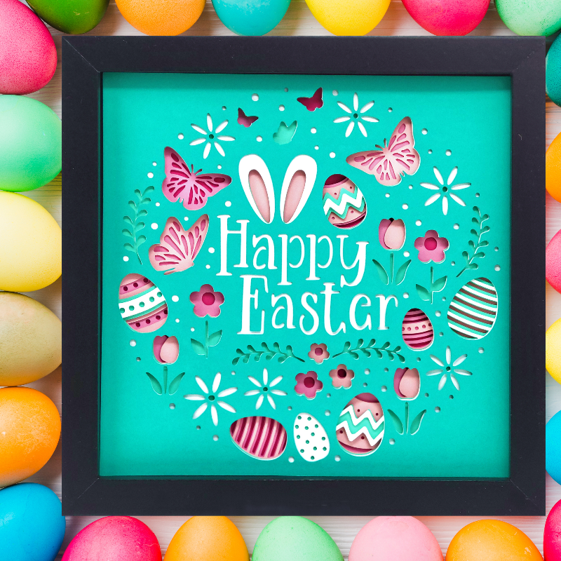Framed 'Happy Easter' sign with colorful eggs and butterflies on a wooden background.
