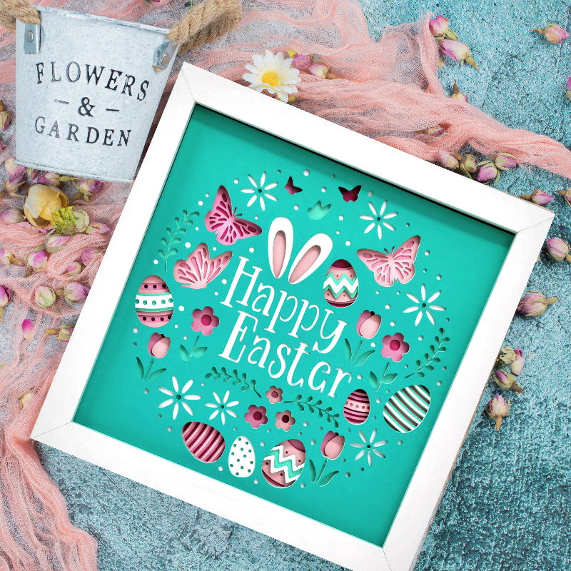 Framed 'Happy Easter' artwork with decorative elements on a textured surface.