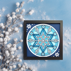 Framed snowflake art on a blue background with decorative branches.
