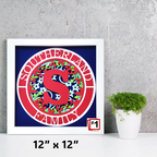 Framed artwork with a red 'S' and floral design on a blue background, placed on a gray surface with a plant.