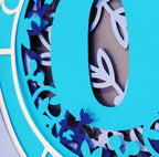 Decorative letter 'O' with floral patterns on a blue background