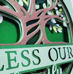 Decorative wall art with tree design and text on a green background