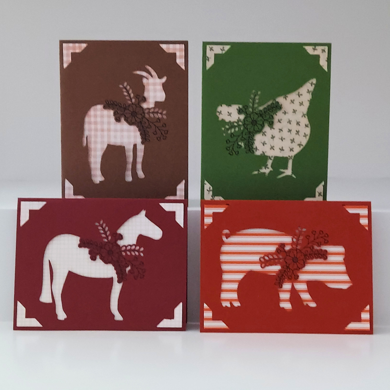 Four greeting cards with animal illustrations on a white background