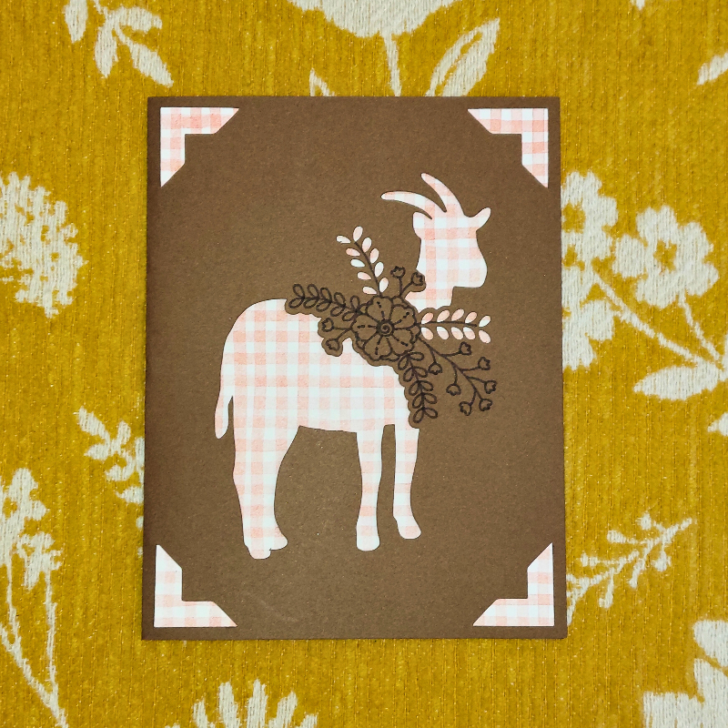 Card with a goat illustration on a floral patterned background