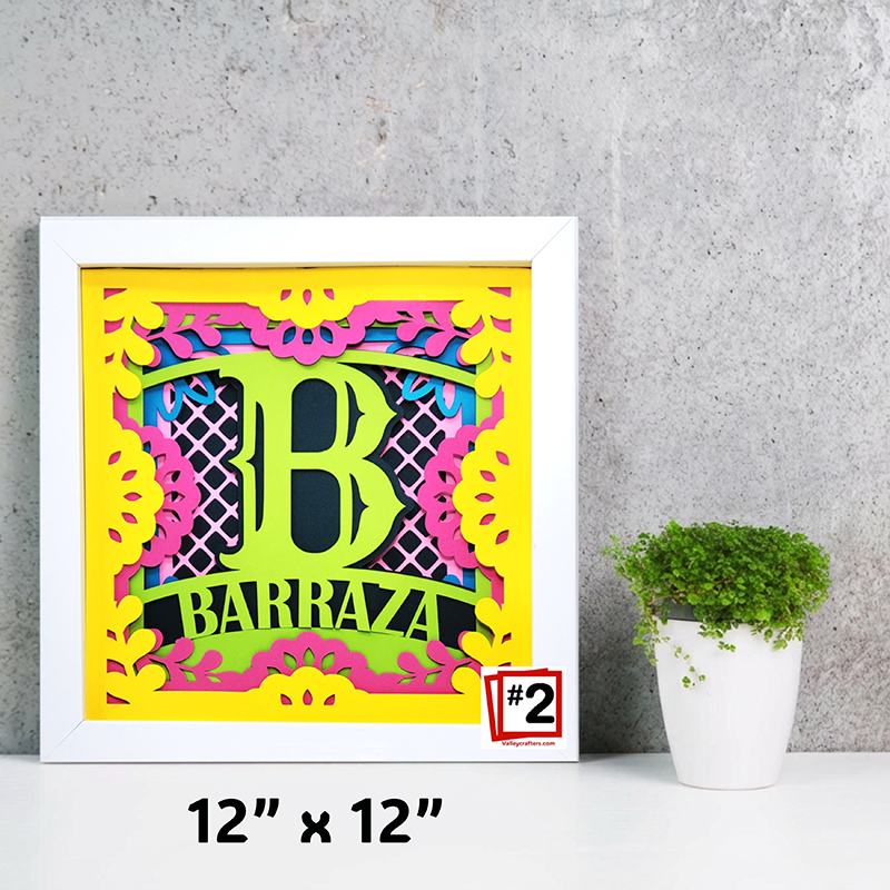 Colorful framed artwork with letter 'B' and text on a gray wall background